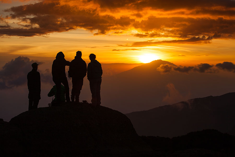 Kilimanjaro/Tanzania - January 26, 2018: A group of hikers watching sunset on mount Kilimanjaro in on of the camps.